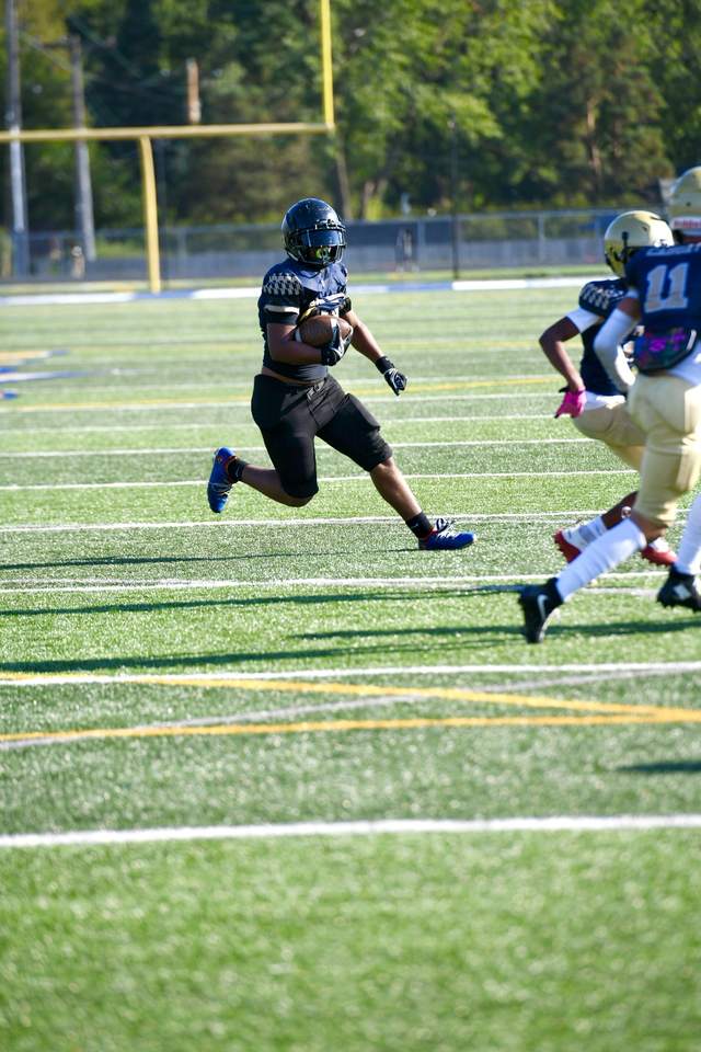 612 Promise running back breaking into open field during a game